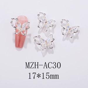 Detail of aurora butterfly nail charms with iridescent wings and tiny pearls 17x15mm