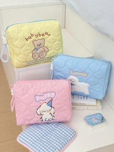 Quilted pouch detail with cute animal embroidery in pastel colors for travel storage