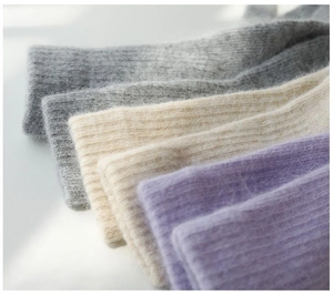 Close-up of thick ribbed knit plush socks in four soft colors for winter warmth