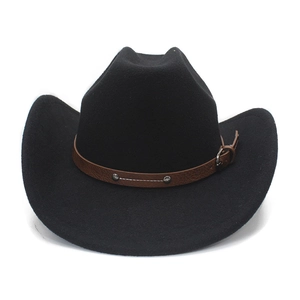 Detail of black felt cowboy hat featuring brown leather band with silver metal studs