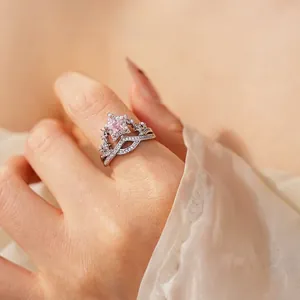 Silver crown ring set with pink star-shaped zircon and V-shaped pavé band