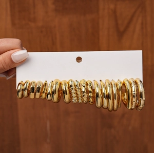 Detailed view of 20-piece gold geometric twisted earring set on display card