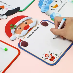 Close-up of a hand writing on a reusable Christmas-themed whiteboard with various holiday shapes