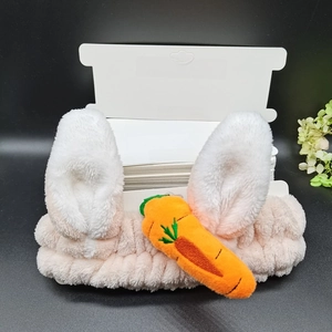 Pink plush headband with bunny ears and carrot design on white display card