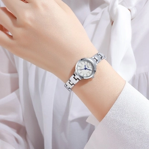 Elegant silver quartz watch for women featuring a white dial and blue hands on wrist