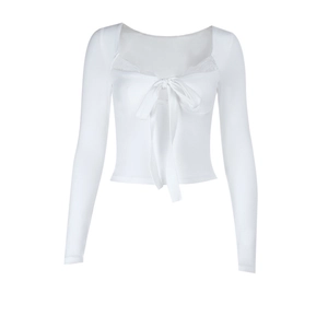 Detail of white long sleeve top with bow lace trim and delicate ribbon tie front