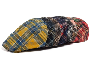 Collection of seven distressed vintage plaid flat caps in various retro color patterns