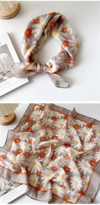 Detailed macro view of daisy floral pattern on soft taupe cotton-linen square scarf