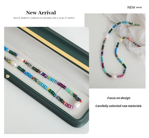 Detail of colorful geometric beads and natural pearls on a bohemian style necklace
