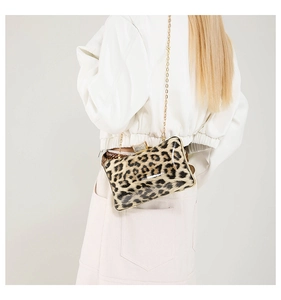Rear view of a model wearing the square leopard print clutch bag with a gold chain strap