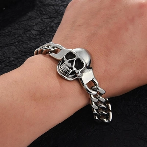 Punk silver metal skull bracelet for men with chunky chain shown on male wrist