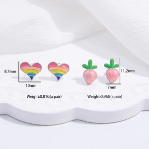 S925 silver heart and carrot stud earrings set with colorful enamel on a white dish