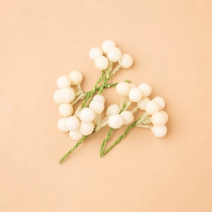 Frosted white decorative berries with green wire stems for DIY Christmas floral arrangements
