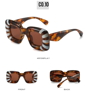 Detail view of square oversized Y2K sunglasses with tortoise pattern and silver stripe accents