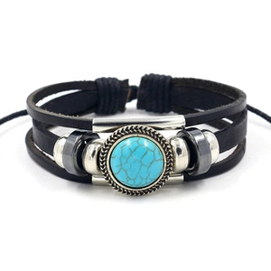 Detail of multi-layer leather bracelet with turquoise stone and bohemian metal accents