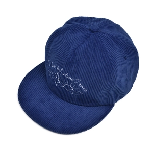 Detail of navy corduroy baseball cap with white cactus embroidery and text