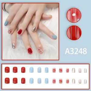 Colorful mixed short press-on nails set in red, blue, and silver with polka dots