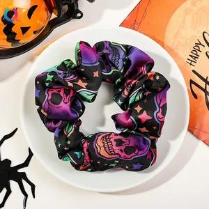 Detailed view of Halloween scrunchie with pop art skulls and festive party decorations