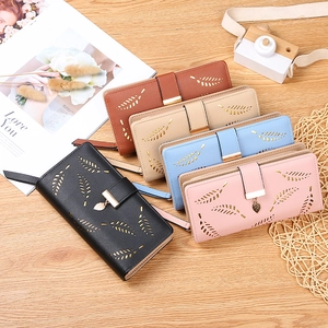 Women's leaf hollow long wallets in five colors displayed on a rustic wooden table