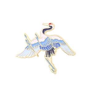 Exquisite crane enamel brooch pin with golden metal frame and blue wing details