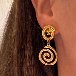 Polished 18K gold stainless steel double spiral drop earrings on a female model