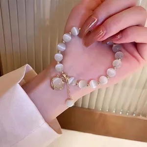 Cat's eye stone beaded bracelet for women featuring a golden cat charm and sleek finish