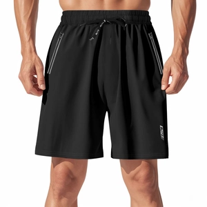 Close-up of quick-dry sports shorts featuring waterproof zipper pockets and elastic drawstring