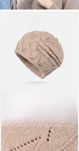 Macro detail of beige hollow-out knit hat featuring delicate mini pearl embellishments