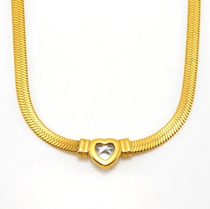 Detail of 18K gold plated snake chain necklace with sparkling heart zircon pendant