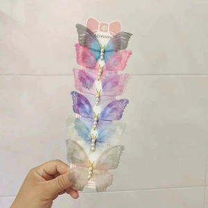 Detail of 6-piece gradient tulle butterfly hair clips with pearls on display card