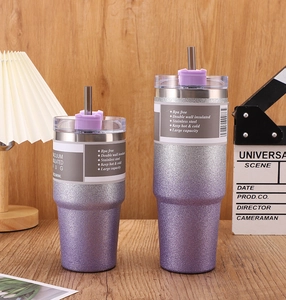 Macro view of purple glitter double wall insulated stainless steel tumblers on wood