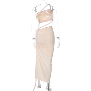 Detail of the elegant peach-pink ruched two-piece set featuring a halter top and long skirt