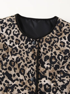 Detail of leopard print quilted jacket featuring black crew neck and button closure