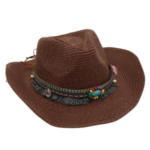 Detail of western cowboy straw hat with ethnic beaded band and turquoise coin pendant