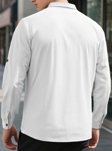 Detail shot of the back of a men's white linen shirt showing premium textured fabric finish