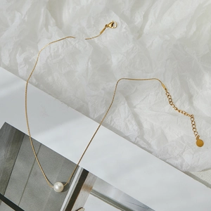 Minimalist single pearl pendant necklace on a gold titanium steel chain with lobster clasp
