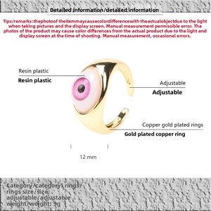 Detailed view of pink resin evil eye ring with adjustable gold plated copper band