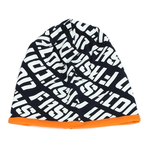 Detail of black beanie featuring white fashion letters and a vibrant orange trim edge