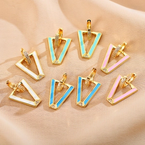 Detailed macro view of V-shaped enamel earrings with sparkling pavé micro-diamonds