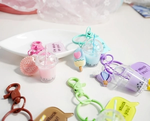 Detailed view of cute bubble tea bear charms with biscuit and heart keychain accessories