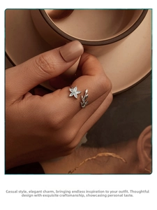 Detail of s925 silver open ring with green flower and olive leaf on finger