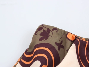 Macro detail of the woven cotton fabric texture with abstract swirls and leaf patterns