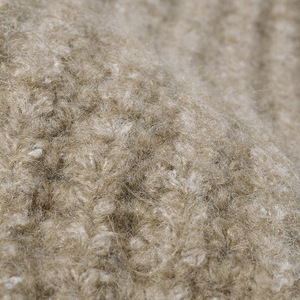 Thick warm knit beanie in beige wool texture with soft fuzzy fiber finish for winter