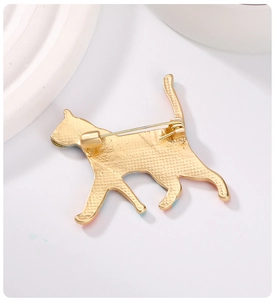 Detailed back view of cat enamel brooch with golden metal texture and safety pin clasp