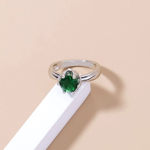Macro shot of 925 silver ring featuring a round green gemstone in a four-claw setting
