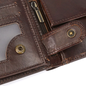 Macro view of genuine leather wallet showing card slots, metal snap and zipper detail