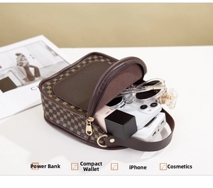 Detail view of vintage polka dot pouch interior holding power bank, phone and cosmetics