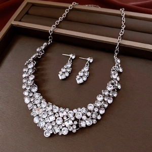 Close-up of elegant silver necklace and earring set with sparkling rhinestones in a gift box