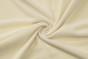 Detailed close-up of beige mesh fabric texture with elegant draping and spiral fold effect