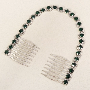 Detail of bridal hair comb with green faceted gems and sparkling crystals on silver chain